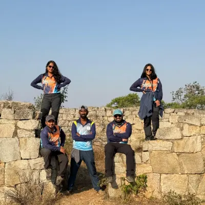 A corporate team posing on ancient fort walls during a morning trek. We organized this outing to celebrate Women's Day, combining adventure with team unity.