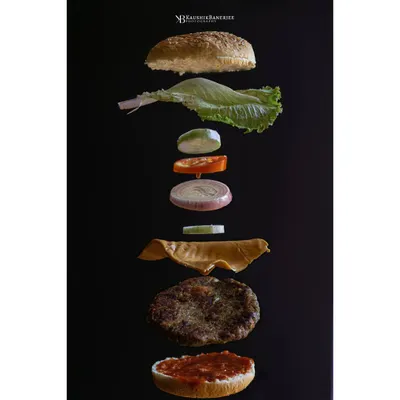 A deconstructed gourmet burger, captured mid-air. This levitation shot is a perfect example of how I blend technical precision with creative imagination to make every ingredient the hero.
