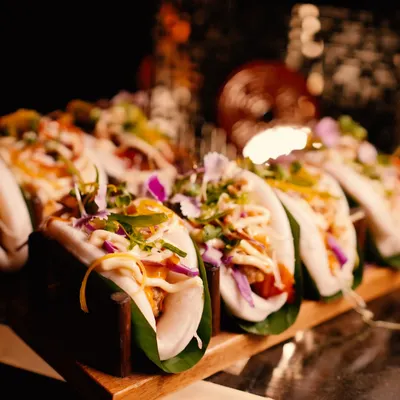 An artful display of our signature bao buns, filled with vibrant ingredients and drizzled with sauce. These fluffy, flavourful bites are a modern Pan-Asian favourite, perfect for networking events.
