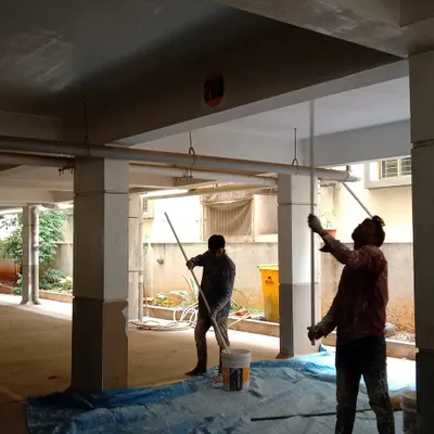 Our team painting the beams and ceiling in a commercial parking area. We are experienced in handling the specific requirements of commercial properties, including durability and safety.