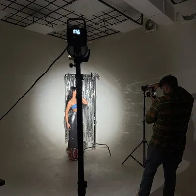 Here's a look at a studio setup. We're using a single hard light and a silver backdrop to create a high-energy, glam-rock feel.