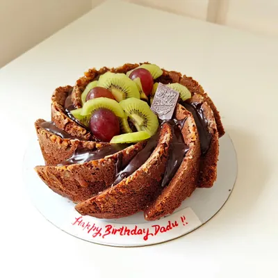 This is a perfect example of my wholesome baking, a whole wheat Bundt cake made for a birthday. It's topped with a rich chocolate ganache, fresh kiwi, and grapes, proving that healthy can be celebratory and delicious.