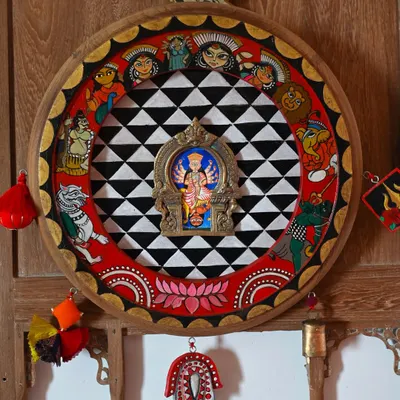 The completed Durga frame, a tribute to the goddess of strength. The outer ring is painted with her family and the story of her victory over Mahisasura, inspired by puja pandals.