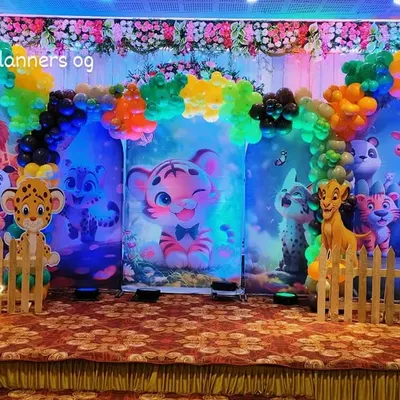 A full view of our vibrant jungle theme party setup in a banquet hall. We use multiple backdrops, a picket fence, and character cutouts to create an immersive safari experience for the little one's first birthday.