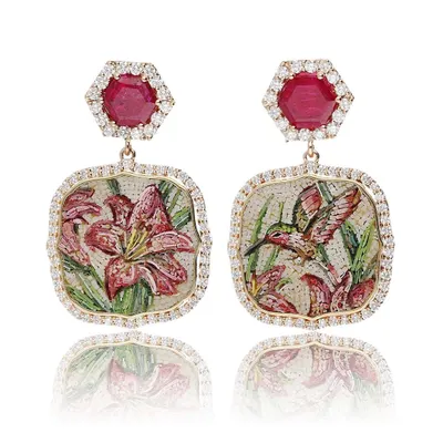 Inspired by the fluttering wings of a hummingbird, this pair of earrings captures a story in two parts. One shows the bird poised to take nectar from the lilies depicted on the other, all handcrafted in micromosaic with non-heated Mozambique rubies.