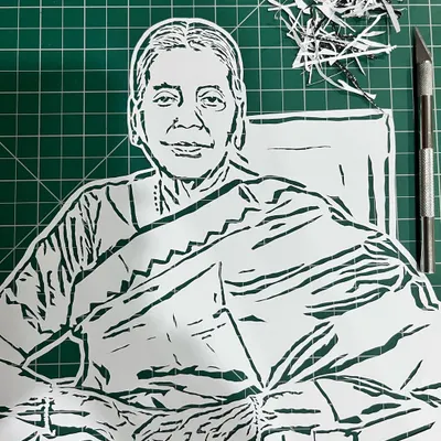 Here is a finished cut on my work mat, right next to the knife I used. You can see the tiny paper scraps that are carved away to reveal the image.