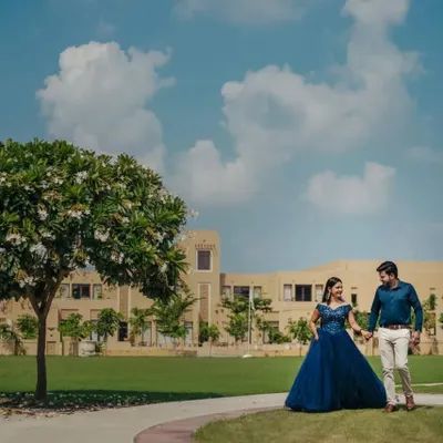 Our navy blue ball gown is a sophisticated choice for a pre-wedding shoot. The rich color and classic silhouette look stunning against the lush green and bright blue sky of this beautiful location.