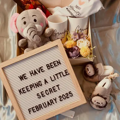 This pregnancy announcement hamper is such a sweet way to share your secret. It includes a letterboard, "grandparents" mugs, a soft toy, and adorable baby booties.