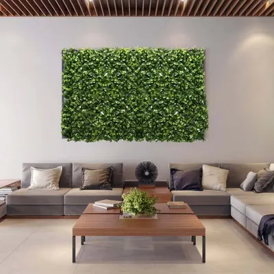 A modern and sophisticated lobby design where I used artificial green panels as wall art, complementing the clean lines and neutral tones.