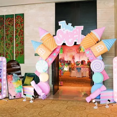 The grand entrance to a "Two Sweet" Candyland party. I used giant ice cream cone and candy props to build an archway, immediately immersing guests in the theme.