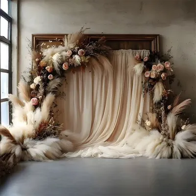 This dreamy boho backdrop is crafted with soft, flowing fabric and an arch of pampas grass and dried florals. It provides a romantic and textural background ideal for a ring ceremony or bridal shower.
