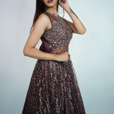 This deep brown sequined gown is perfect for an evening reception or cocktail party. The sheer neckline adds a touch of allure.