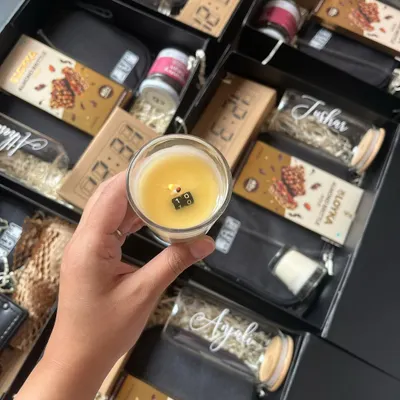 I had the honor of curating these bespoke 10th-anniversary gift hampers for Bloomberg. This image shows a personalized candle with a hidden message, one of ten items in the box.