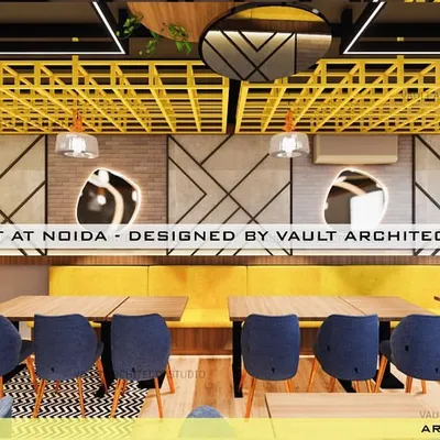 A 3D render of the Kaala Namak restaurant, showcasing the vibrant dining area. The design uses a bold yellow ceiling lattice, geometric wall patterns, and comfortable seating to create a modern and energetic vibe.