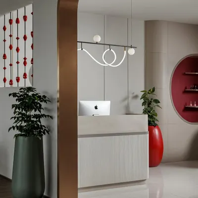 The entrance to the salon, where a metallic archway frames the sleek, minimalist reception desk, immediately setting a tone of modern luxury.