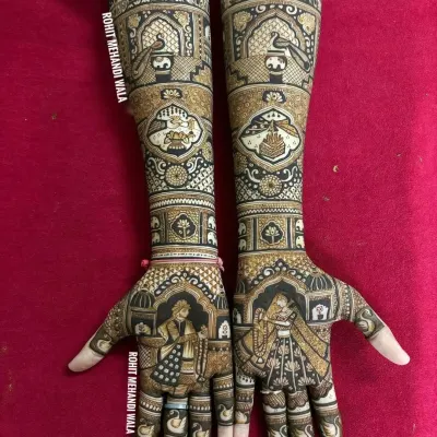This full-arm design features a beautiful bride and groom portrait on the palms, set within an arch. The artwork extends up the arms with traditional symbols like the kalash, showcasing a blend of personal and classic elements.