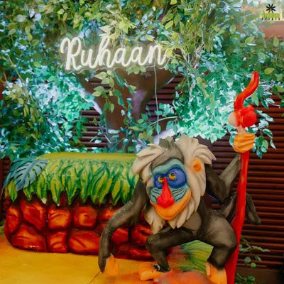 A detail from our Jungle Theme birthday decor. Featuring Rafiki from The Lion King and a custom neon name sign, we bring beloved characters to life.