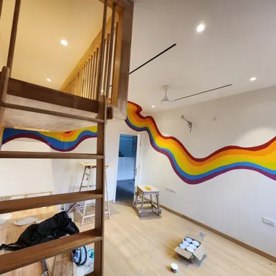 We created this flowing rainbow mural for a child's bedroom, designed to wrap around the room and connect the lower level with the wooden loft bed.