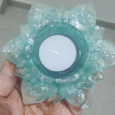 This hand-held view shows the delicate beauty of my resin T-light holders. This one is made with a light blue resin and sparkling silver flakes, creating a lovely effect when lit. These are a popular choice for elegant wedding return gifts.