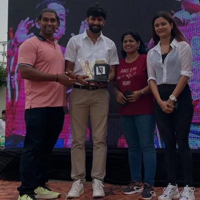 Receiving an award for my contribution to a family fitness event. It is an honor to be recognized for my work in promoting a healthy lifestyle.