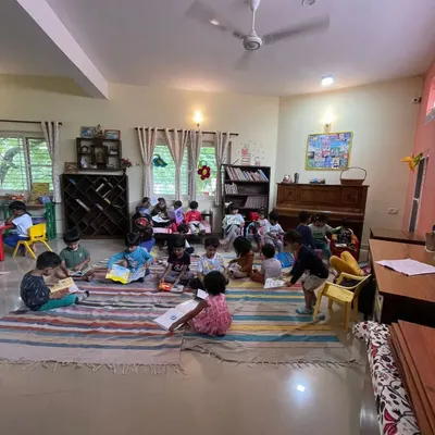 A wide view of our library during a silent reading session. Children are scattered around the room, each lost in their own book, creating a peaceful and studious atmosphere.