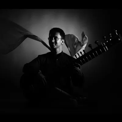 A dramatic black and white studio portrait. This artistic style is great for album covers and cultural event promotions.
