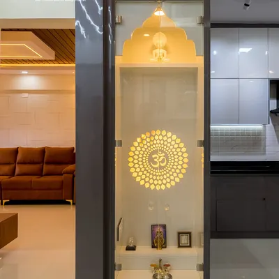 This sleek, modern pooja unit is designed to fit perfectly between a pillar and a wall. The backlit Om mandala creates a divine glow, and the glass doors keep the space serene and dust-free.