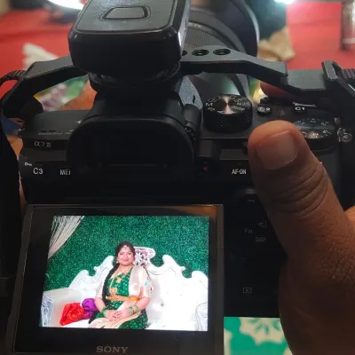We provide in-house photography services to capture your special moments. This image shows our photographer in action during a baby shower.
