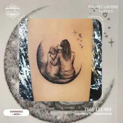 A beautiful memorial tattoo for a pet lover, showing a girl and her dog sitting on the moon together. This piece captures the soulful bond between a human and their animal companion.