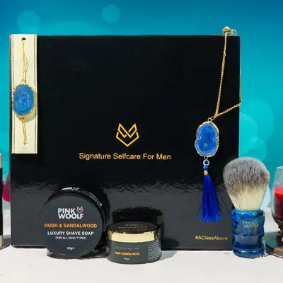 A festive Raksha Bandhan themed product shot for Pink Woolf's men's self-care kit. The image combines the products with traditional elements to create a perfect gift-giving visual.