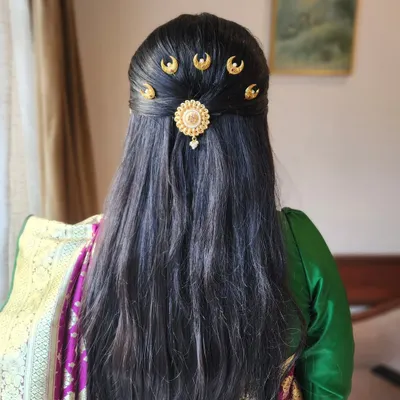A unique and elegant hairstyle featuring traditional half-moon shaped "chandrakor" hairpins, perfect for a classic Marathi look.