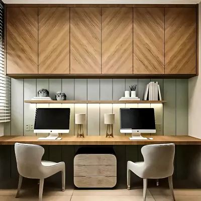 I designed this clean and symmetrical dual-desk workstation for a modern home office. The chevron-patterned wood cabinetry overhead provides ample storage, while the integrated LED lighting ensures a well-lit work surface for two.