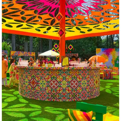 This circular bar was the centerpiece for a vibrant Holi festival. The intricate patterns, custom canopy, and explosive colors show how I can build a high-energy, branded experience for large-scale outdoor events.