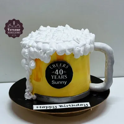 A fun 3D beer mug cake, perfect for a 40th birthday toast. The entire mug is a carved cake, and the frothy foam on top is made from piped whipped cream.