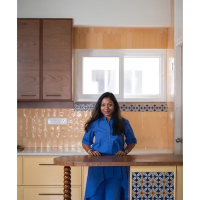 This is me in a recently completed kitchen, from our "Where Daffodils Dance" project. This project was a love letter to serenity, focusing on thoughtful simplicity and creating a sanctuary of peace and calm.