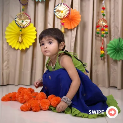 The Nila Ghagra Choli is a favorite for its vibrant colors. The combination of a parrot green choli and a royal blue skirt with a ruffled hem is designed to make your little girl feel special and ready to celebrate.