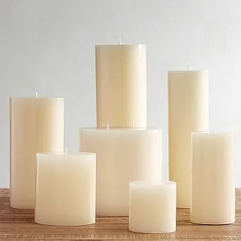 An assortment of my ivory pillar candles in various heights and widths, ready for a bulk order. This shows the scale and variety I can supply for large events or hospitality clients.