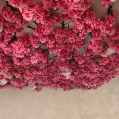A view looking directly up at the dense pink artificial cherry blossom ceiling I created. This immersive installation provides a powerful visual impact for any interior space.
