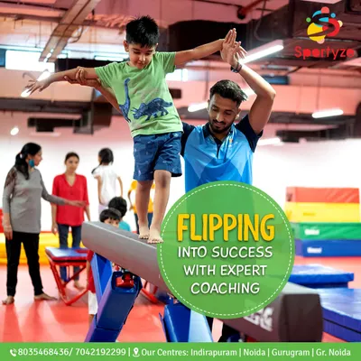 Flipping into success with expert coaching. This picture perfectly captures how our coaches provide hands-on support to help students learn new skills safely on the balance beam.