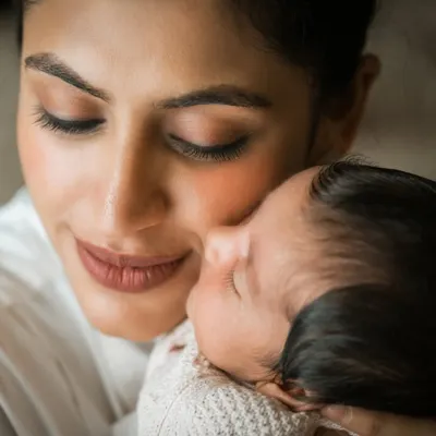 The purest love. This close-up of a mother and her newborn is what lifestyle photography is all about. It's not about the perfect pose, but the real, overwhelming emotion of holding your new baby.