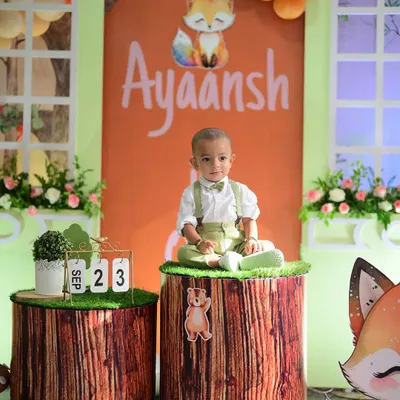The birthday boy himself, sitting like a king in his woodland-themed kingdom. We used tree stump-style pedestals as part of the decor, making for a perfect photo opportunity during his first birthday cake smash session.
