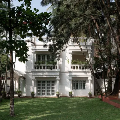 The restored facade of the Ivy Lane Villa is an ode to classic Bangalore bungalows. I preserved the original architecture, including the columns and balustrades, and added a fresh coat of white paint with sage green accents on the windows to give it a signature Furbishy touch.