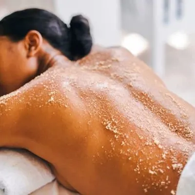 Here you can see a body scrub treatment in progress. This process, known as exfoliation, is excellent for skin renewal and achieving a soft, healthy glow.