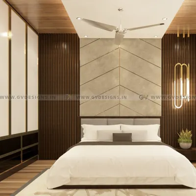 This luxurious bedroom design features a fabric headboard set against a laminate back wall with a sleek T-profile and PVC rafters. The wardrobe combines a gold-color aluminum frame with white and tinted black lacquered glass for a truly opulent feel.