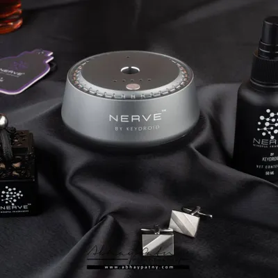 A moody and luxurious shot for a range of car fragrances. The dark, silky fabric and elegant props like cufflinks create a sophisticated atmosphere that aligns with a premium automotive brand.