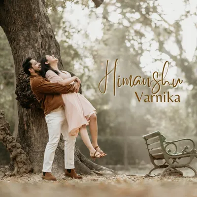 A playful and romantic lift under a beautiful old tree in a park. This image is full of life and joy, capturing the fun side of a couple's relationship during a golden hour shoot.