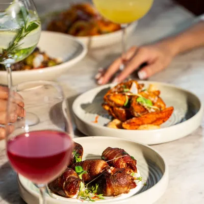 It's a flavor fiesta during my Apero Hour. Indulge in my tapas menu, featuring bites like chorizo-filled dates wrapped in bacon and crispy potato wedges.