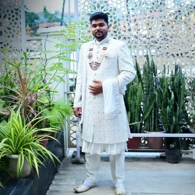 Here is a full-length view of one of my most popular rentals, an all-white sherwani with intricate self-embroidery. It’s a timeless and elegant choice for any groom.