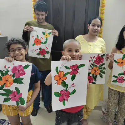 A group of proud artists from Day 1 of our art camp. They just finished their beautiful hibiscus flower paintings, each one a unique expression of what they learned about color mixing and brush strokes.