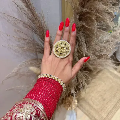 Getting into the Diwali spirit with these bold and beautiful red nails. Paired with traditional jewelry, this classic red manicure is the perfect accessory for the festival of lights.